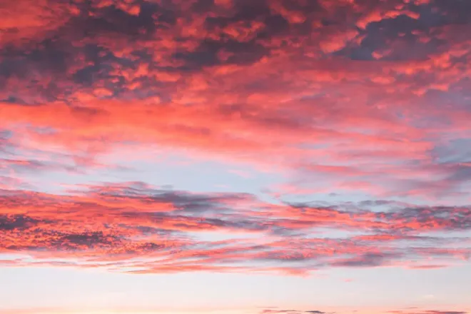 Red and pink clouds lit from below after the Sun has set.